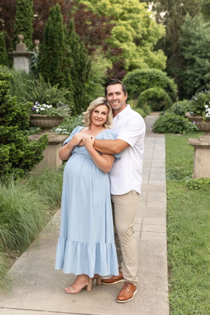 Maternity photographer in Louisville Kentucky captures expectant couple on garden path at Whitehall House and Gardens