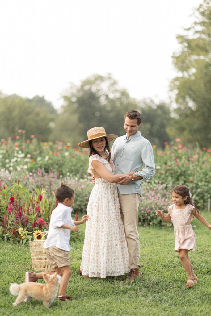 Louisville Kentucky family maternity session with mother, father, toddler daughter, and puppy in flower field at Chickapoo Farm