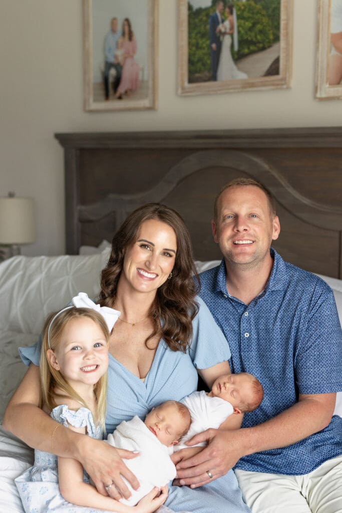 
lifestyle newborn photography Louisville KY family of four with mother father older daughter and newborn baby in bedroom