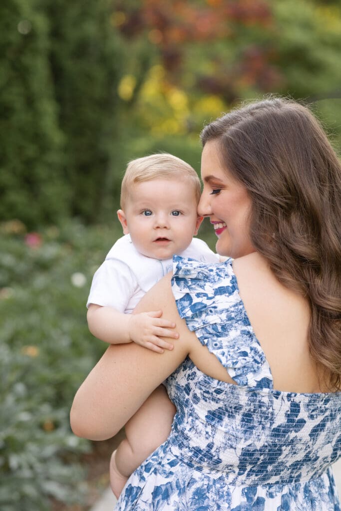 Louisville Kentucky maternity photography featuring mother in blue floral dress with her baby boy at Whitehall House and Gardens